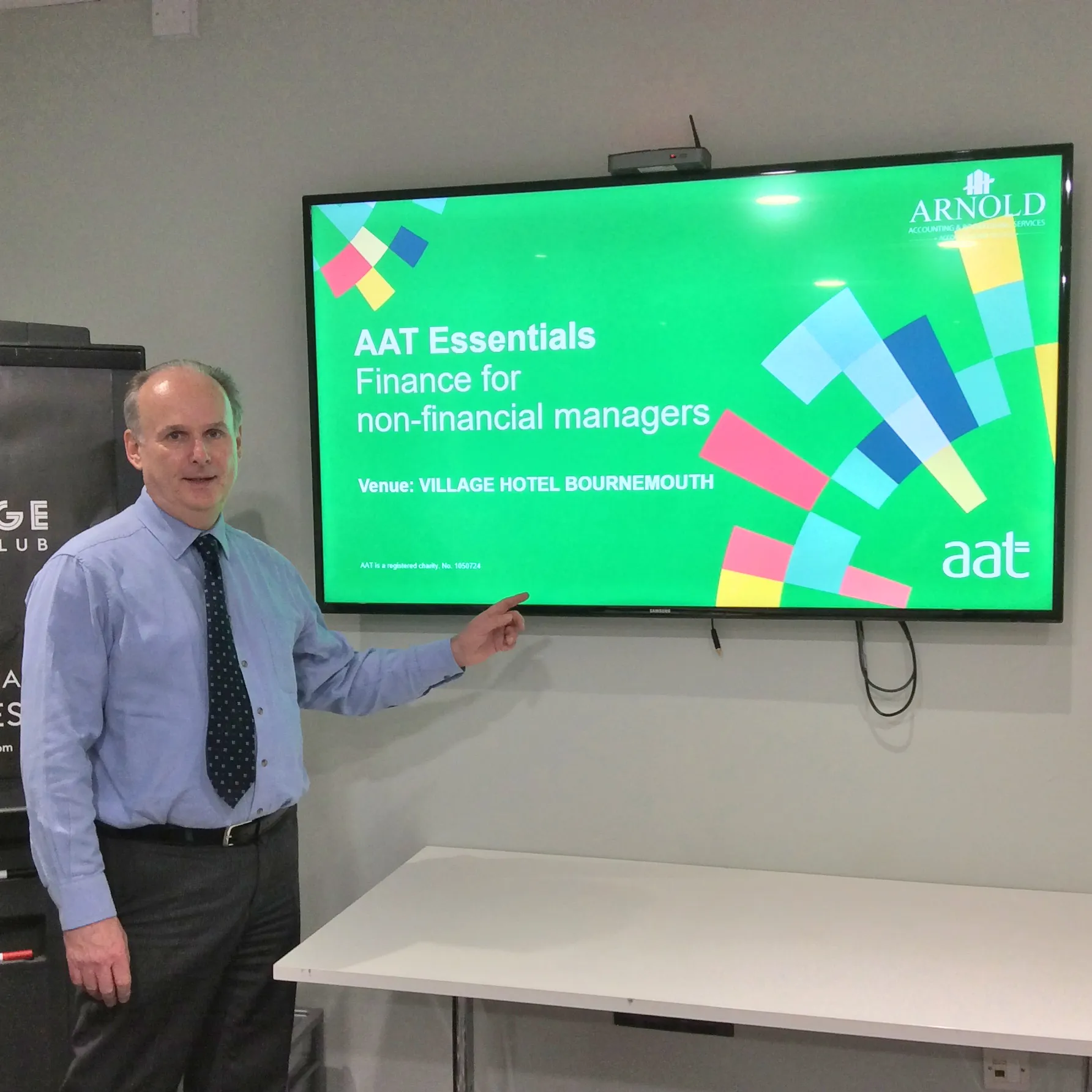 Stephen Arnold beside a screen showing the AAT Essentials course Finance for non-financial managers